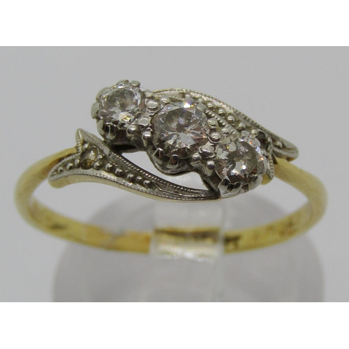 1327 - 18ct diamond crossover type ring, centre stone 0.20ct approx, size Q/R, 2.8g