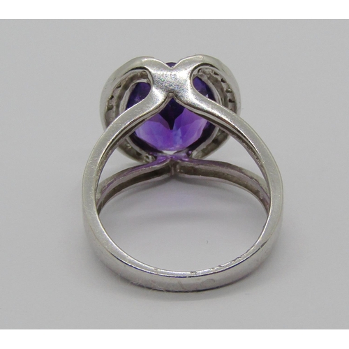 1331 - 18ct white gold oval amethyst and diamond cocktail ring with raised setting, size L/M, 6.2g