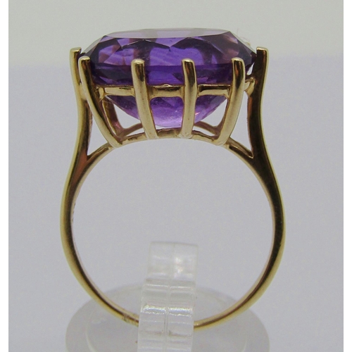 1334 - 9ct claw set oval amethyst dress ring, size Q, 4g