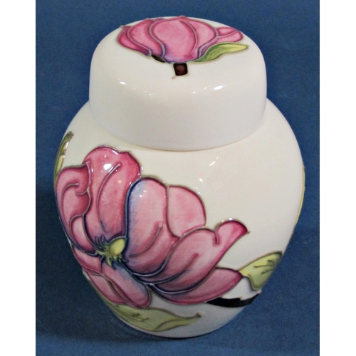 1102 - Three pieces of Moorcroft to include an oviform vase with fruit detail, further shallow dish and a G... 