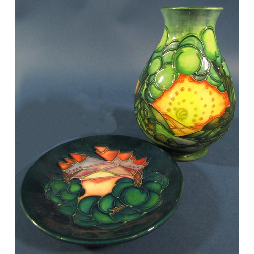 1102 - Three pieces of Moorcroft to include an oviform vase with fruit detail, further shallow dish and a G... 