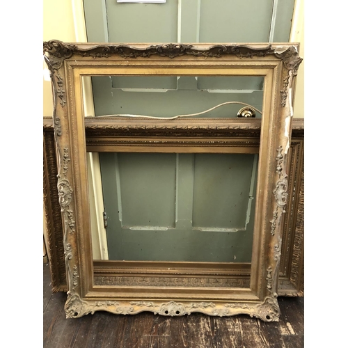 75 - Two Victorian Gilt Wood and Gesso Frames with laurel leaf details (84 x 122 cm) and scrolling Rococo... 