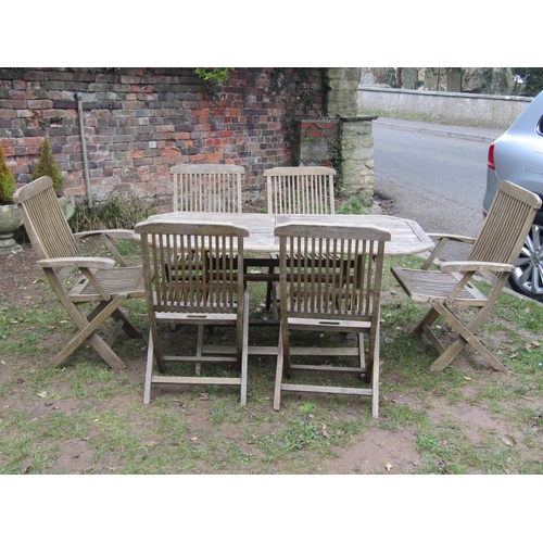 2050 - A weathered teak rectangular folding garden table with canted corners and slatted top, 150 cm x 80 c... 