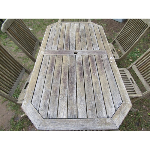 2050 - A weathered teak rectangular folding garden table with canted corners and slatted top, 150 cm x 80 c... 