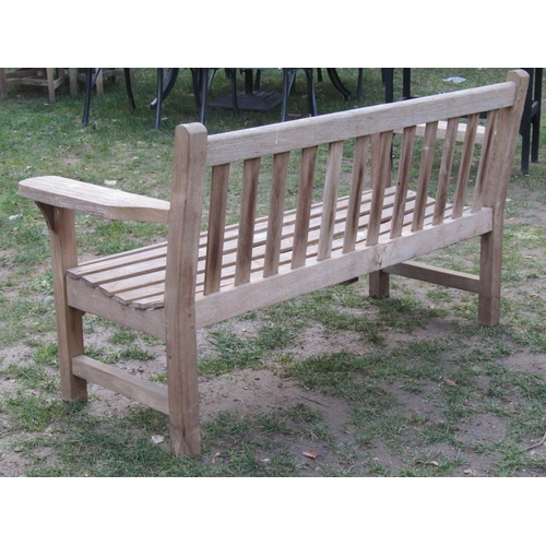 2052 - A weathered teak garden bench with slatted seat and back, 154 cm wide (af)