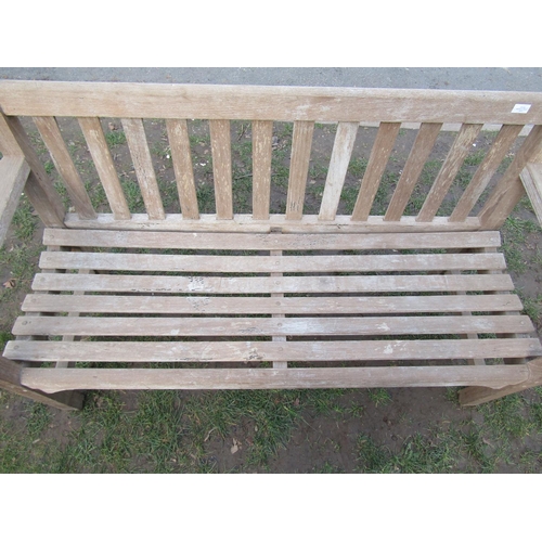 2052 - A weathered teak garden bench with slatted seat and back, 154 cm wide (af)