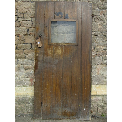 2095 - An antique pine ledge and brace internal door with scumbled finish and thumb latch fitting enclosing... 