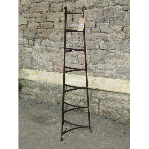 2098 - A heavy gauge coated steel seven tier saucepan stand, 129 cm high, together with two steel fire iron... 