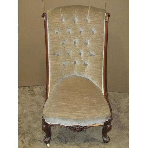 2158 - A Victorian nursing chair with upholstered seat and button scrolled back within a walnut show wood f... 