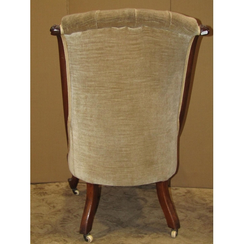 2158 - A Victorian nursing chair with upholstered seat and button scrolled back within a walnut show wood f... 