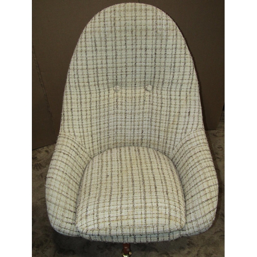 2159 - A retro Greeves & Thomas swivel egg type chair with upholstered finish raised on X framed supports w... 