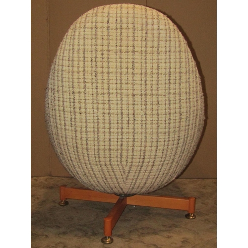 2159 - A retro Greeves & Thomas swivel egg type chair with upholstered finish raised on X framed supports w... 