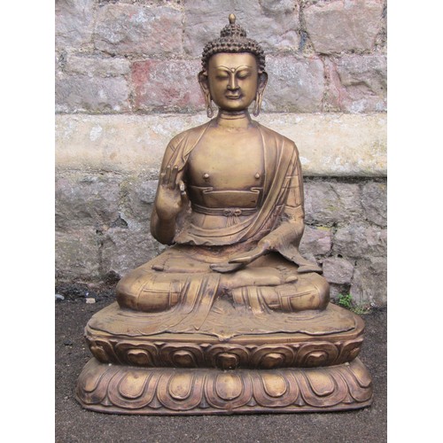 2061 - A hollow cast bronze of a seated Buddha raised on a lotus base, 70cm high