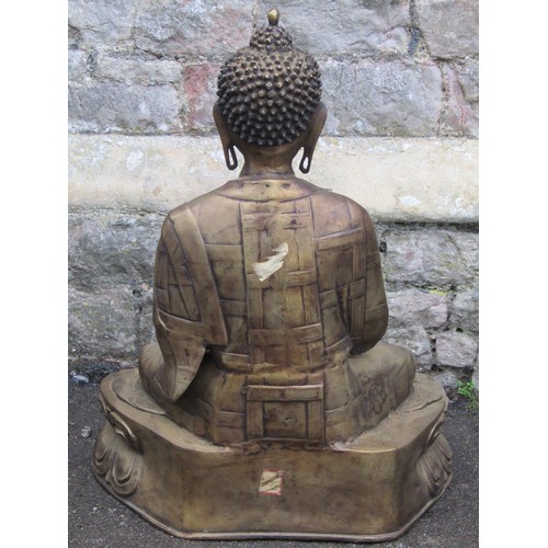 2061 - A hollow cast bronze of a seated Buddha raised on a lotus base, 70cm high