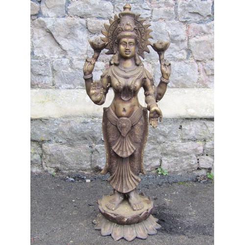 2062 - A hollow cast bronze Hindi goddess Lakshmi with four arms standing on a lotus base, 82cm high