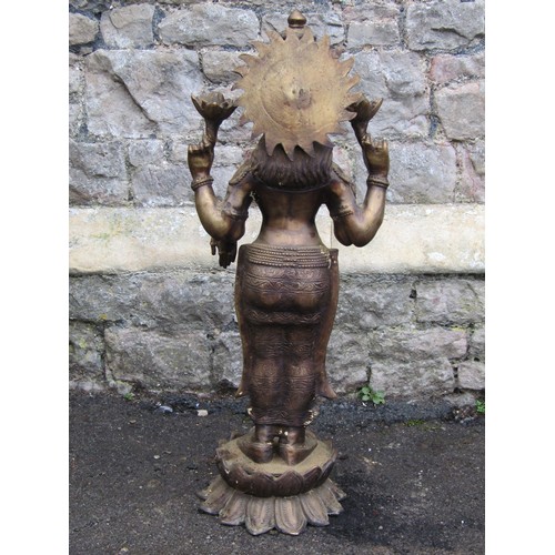 2062 - A hollow cast bronze Hindi goddess Lakshmi with four arms standing on a lotus base, 82cm high