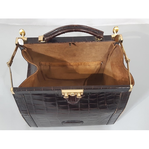 1634 - Crocodile skin bag  with gladstone style opening, lock/ key, suede lining 30x28x19cm together with a... 