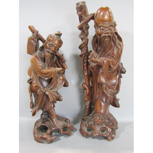 1518 - Two Chinese hardwood carved figures of wise old men together with three stone effect dogs of Fo (5)