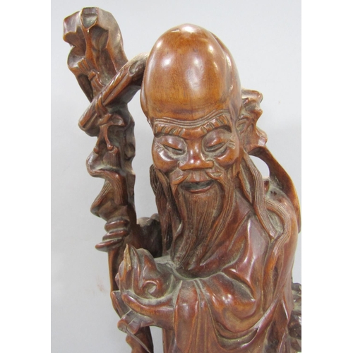 1518 - Two Chinese hardwood carved figures of wise old men together with three stone effect dogs of Fo (5)