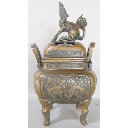 1524 - A Chinese bronze koro and cover with a mystical beast, stamped to the base, 22cm high.