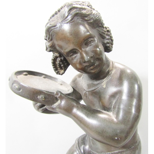 1478 - A spelter statue of a young girl doing a jig and playing a tambourine, raised on a socle base, 32cm ... 