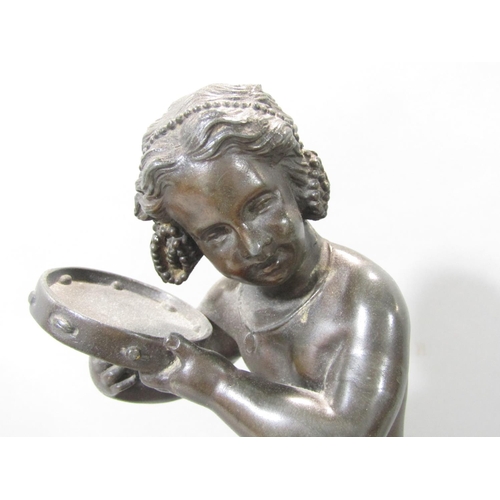 1478 - A spelter statue of a young girl doing a jig and playing a tambourine, raised on a socle base, 32cm ... 