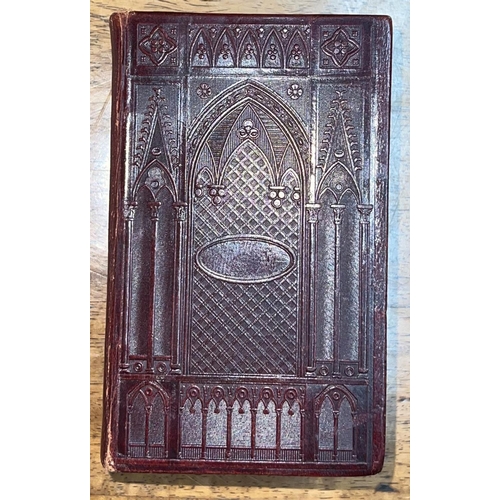 293 - A William IV bible, the dark maroon leather bindings blocked in repeating gothic style architectural... 