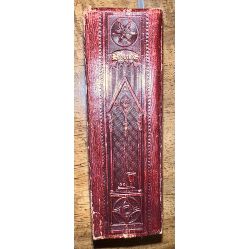 293 - A William IV bible, the dark maroon leather bindings blocked in repeating gothic style architectural... 