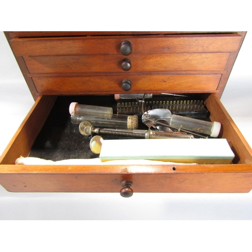 1543 - An Edwardian mahogany dentist’s instrument drawer with a hinged top section containing glass jars, w... 