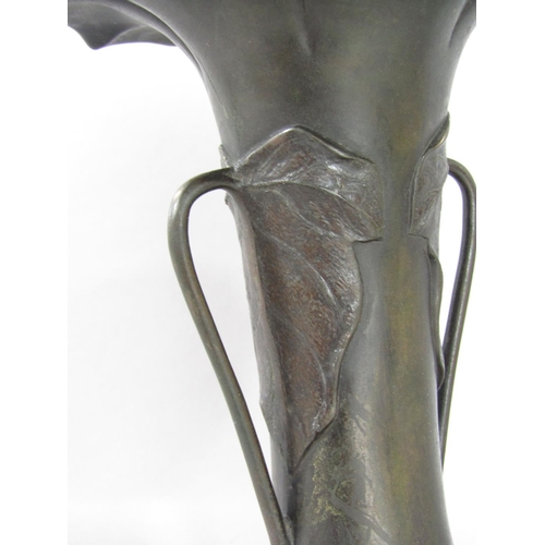 1559 - An early 20th century Art Nouveau bronze vase with a floral flared rim and Lily pad handles 22cm hig... 