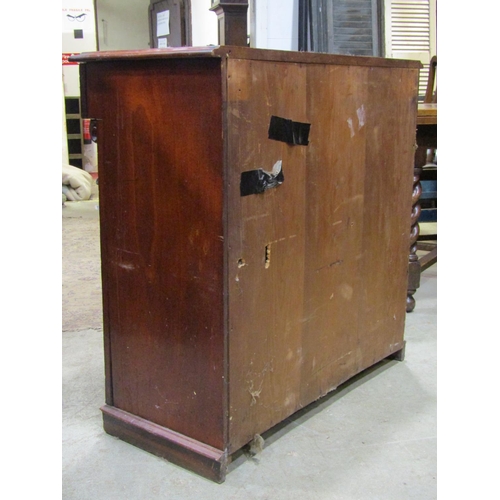 2221 - A Victorian mahogany side cupboard enclosed by a pair of moulded arched panelled doors beneath a mou... 