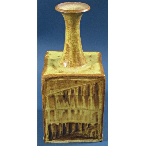 1042 - A studio pottery pot of square cut form with trumpet shaped neck, with simple geometric detail