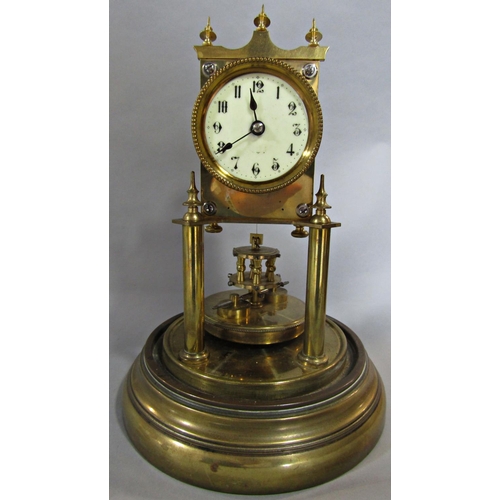 1397 - A brass anniversary clock raised on turned column supports, set beneath a glass dome