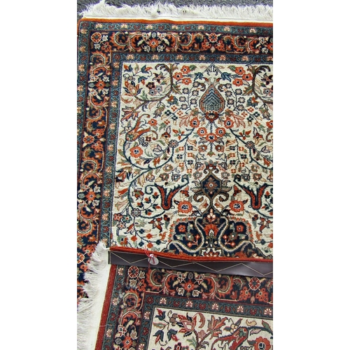 1661 - A Persian Tabriz carpet with an all over floral pattern and a central floral medallion.  160cm x 90c... 