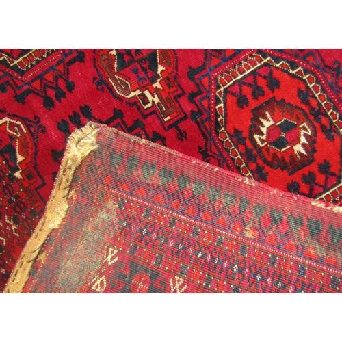 1680 - A short Bokkara runner with two rows of elephant medallions on a predominantly red ground.  150cm x ... 