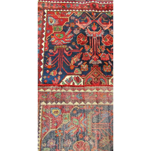 1684 - An early 20th century Baktia carpet with large stylised flowers on a blue ground