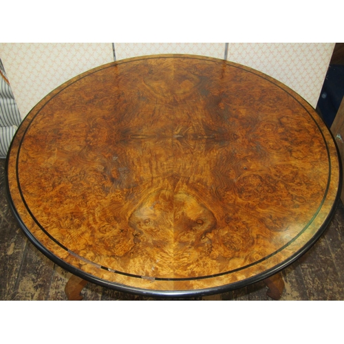 2664 - A circular Victorian walnut and figured walnut centre table, the top quarter veneered and set within... 