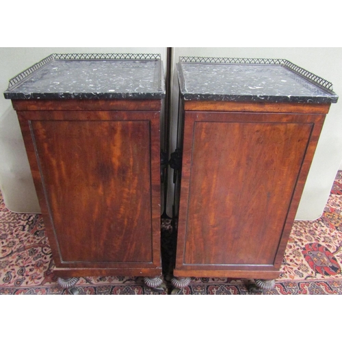 2665 - A pair of Georgian mahogany pedestals of square cut form, set beneath polished marble tops with thre... 