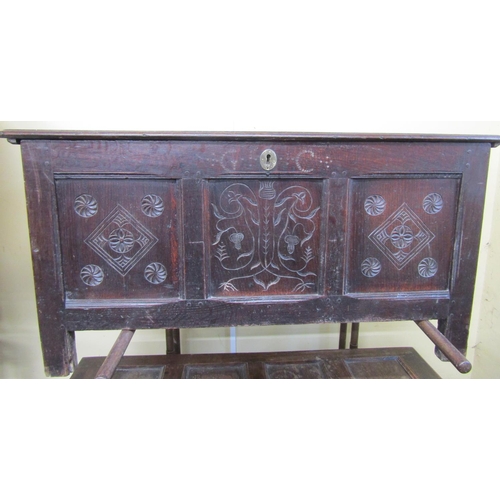 2671 - an 18th century oak coffer, the front elevation enclosed by three panels the central panel with abst... 