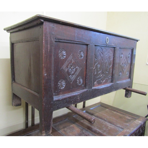 2671 - an 18th century oak coffer, the front elevation enclosed by three panels the central panel with abst... 