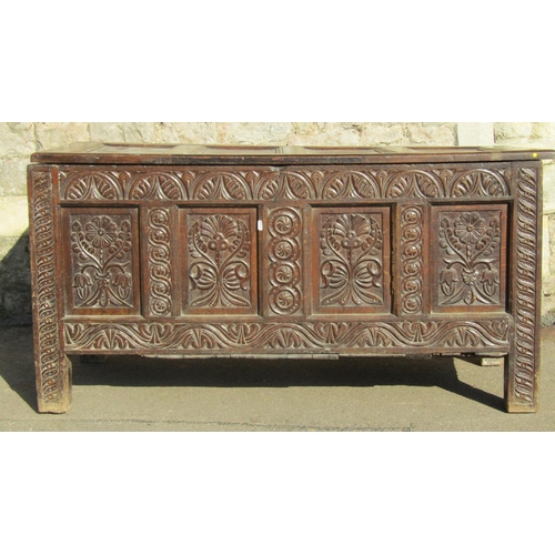 2672 - An 18th century oak coffer, the front elevation enclosed by four panels with repeating floral geomet... 