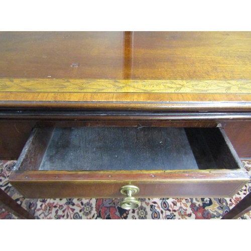 2687 - A rectangular Georgian mahogany foldover top tea table, with cross banding and repeating pen work de... 