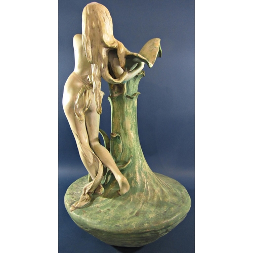 1062B - A Goldscheider style Royal Dux lily vase with a woman embracing the petals, indistinctly signed, 60c... 