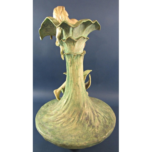 1062B - A Goldscheider style Royal Dux lily vase with a woman embracing the petals, indistinctly signed, 60c... 