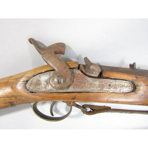 1572 - An 18th century flintlock musket and a 19th century percussion rifle