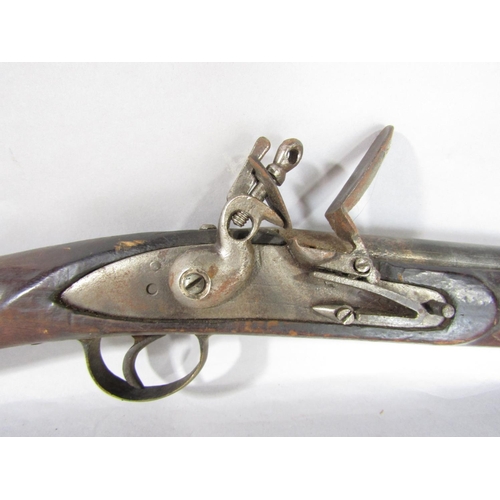 1572 - An 18th century flintlock musket and a 19th century percussion rifle