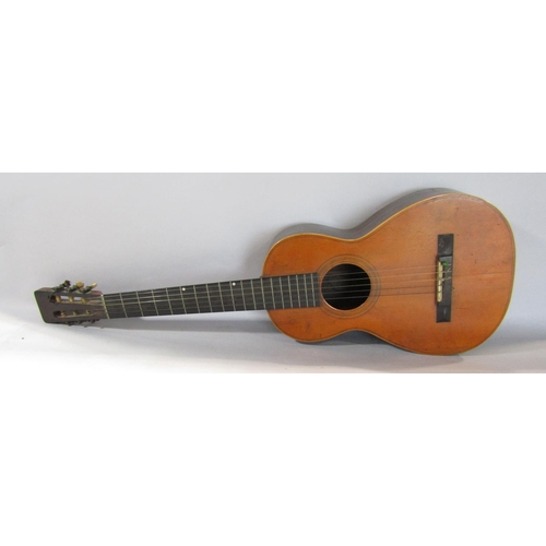 A small six string acoustic Spanish guitar