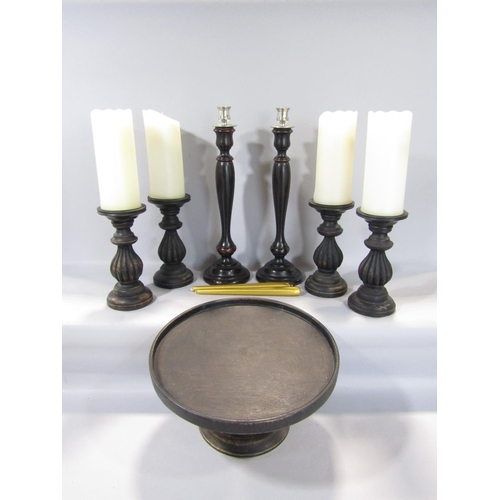 1586 - A timber lazy Susan, four carved timber candlesticks, a further pair, all with ebonised finish