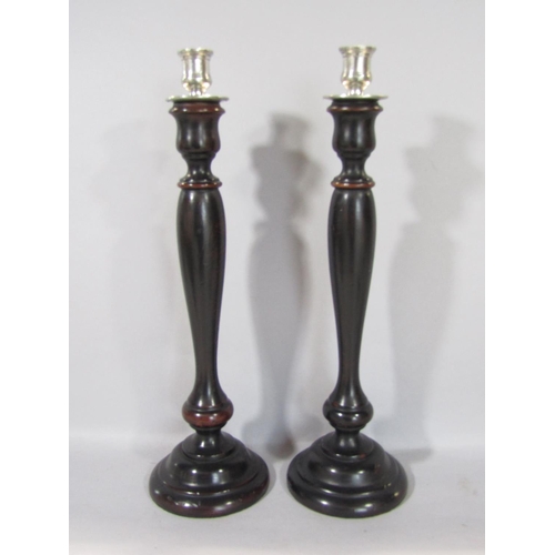 1586 - A timber lazy Susan, four carved timber candlesticks, a further pair, all with ebonised finish