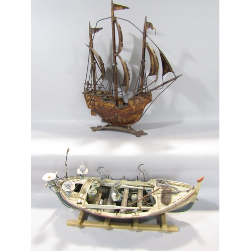 1590 - A three mast galleon in metal under full sail, together with a timber fishing boat, fully fitted wit... 